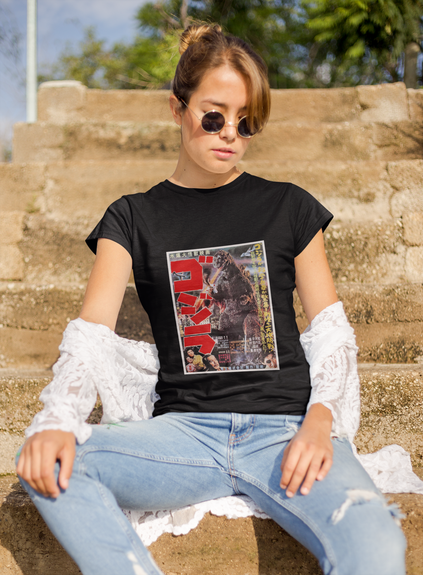 a woman wearing a black japanese godzilla  t - shirt