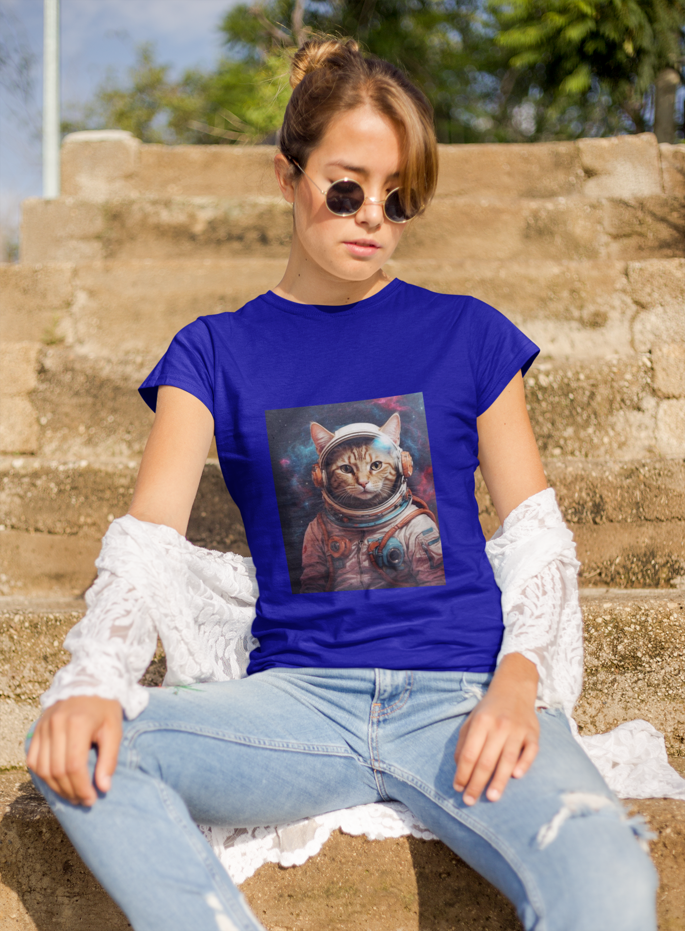 a woman wearing a blue space cat T-shirt