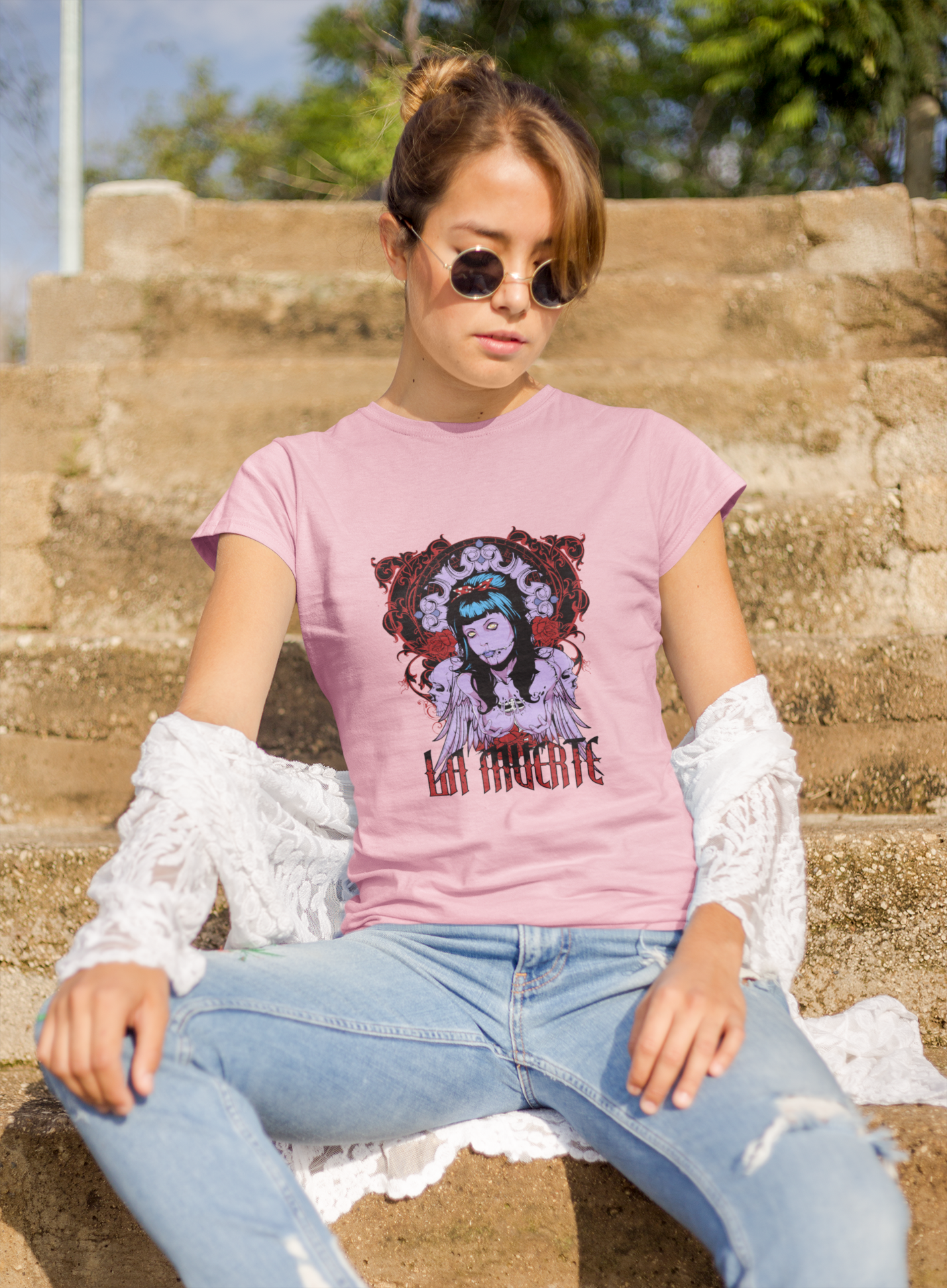 a woman wearing a pink La Muerte T-shirt