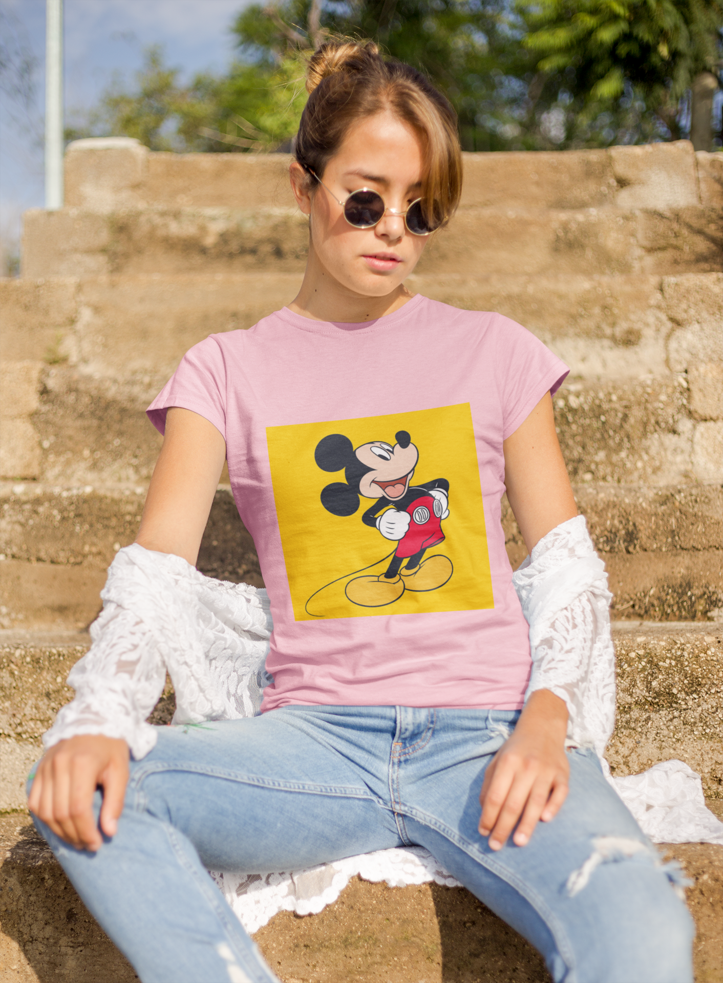 a woman wearing a pink Mickey mouse T-shirt