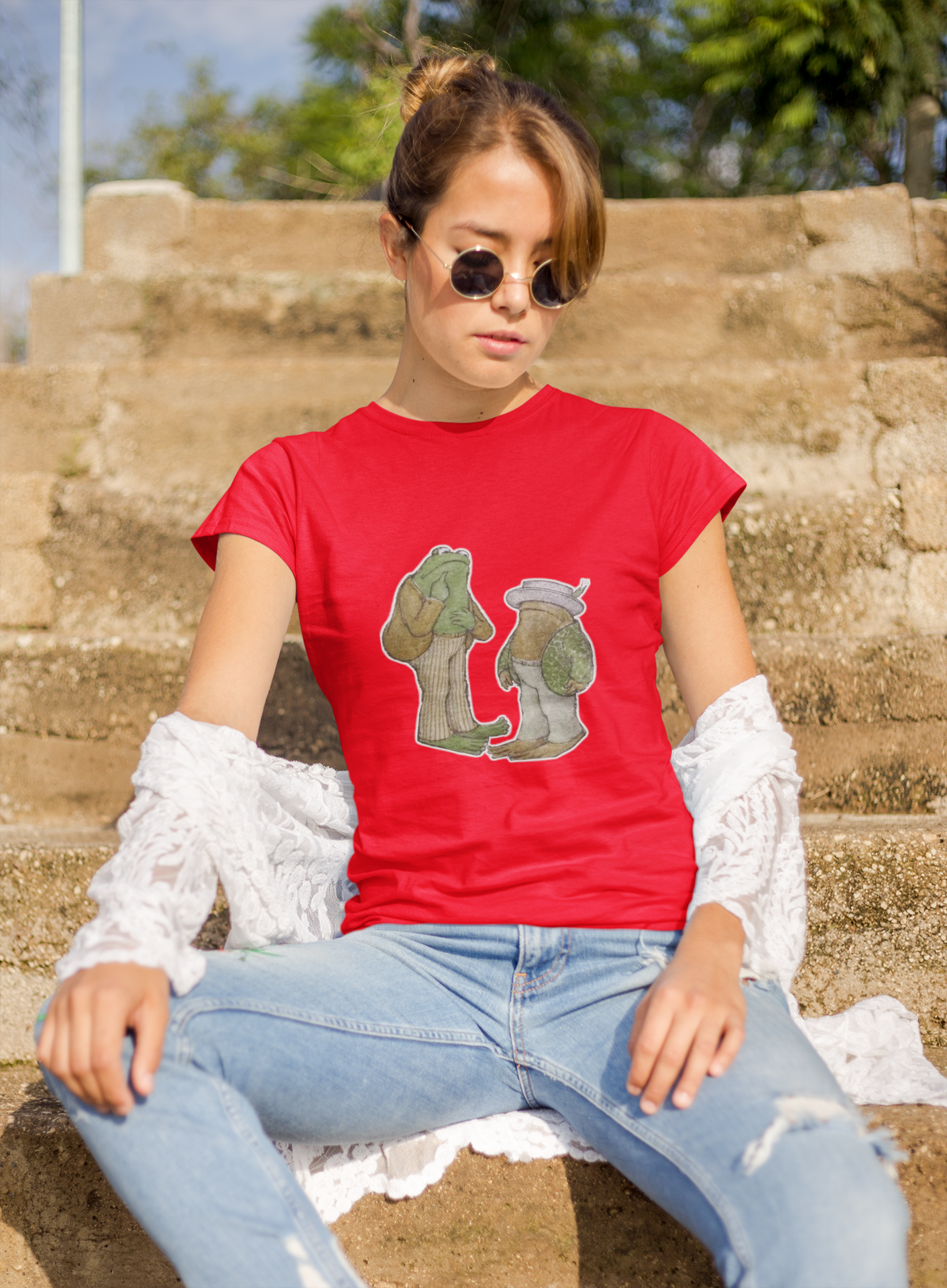 a woman wearing a red frog and toad  t - shirt