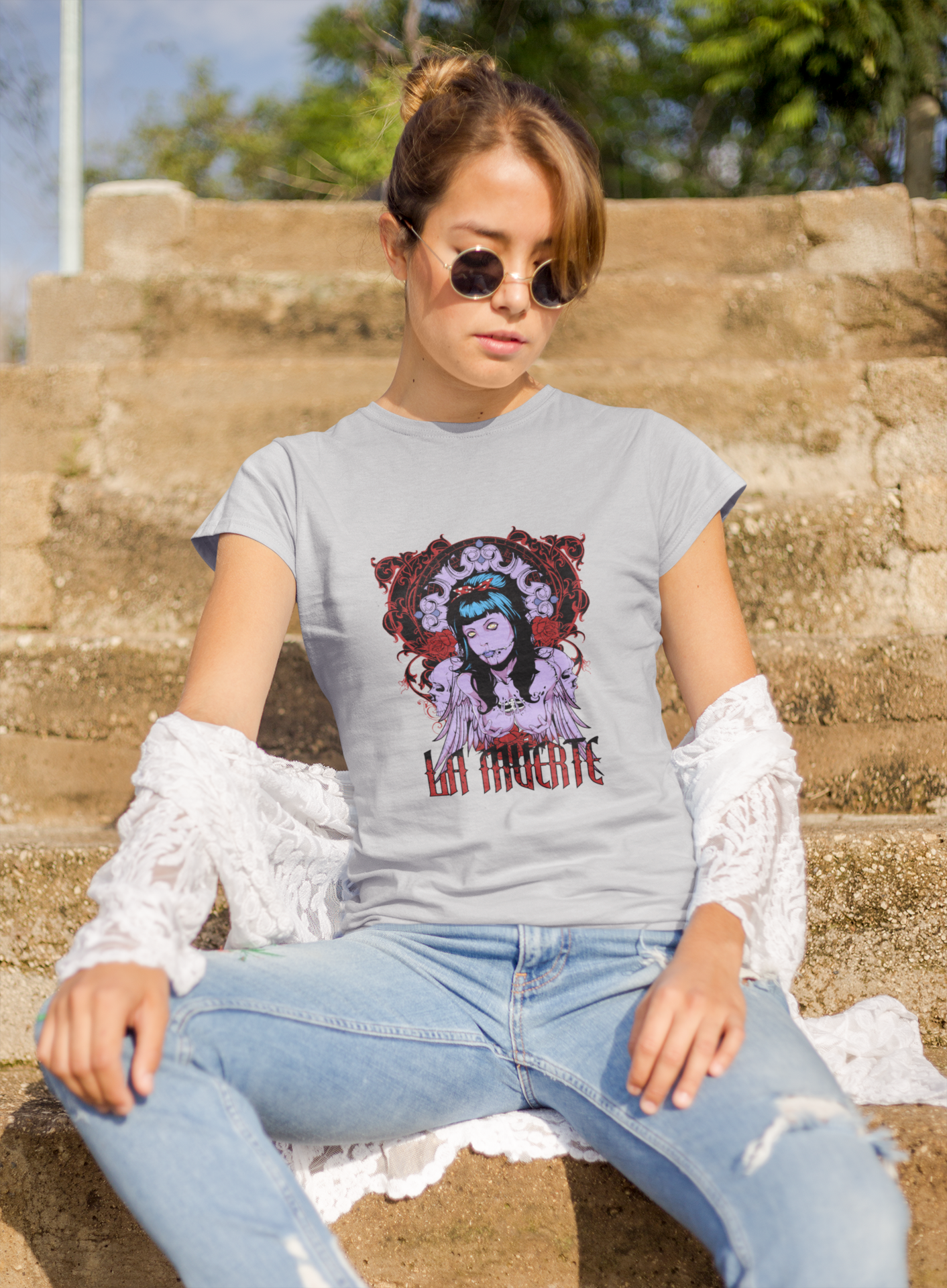 a woman wearing a grey La Muerte T-shirt