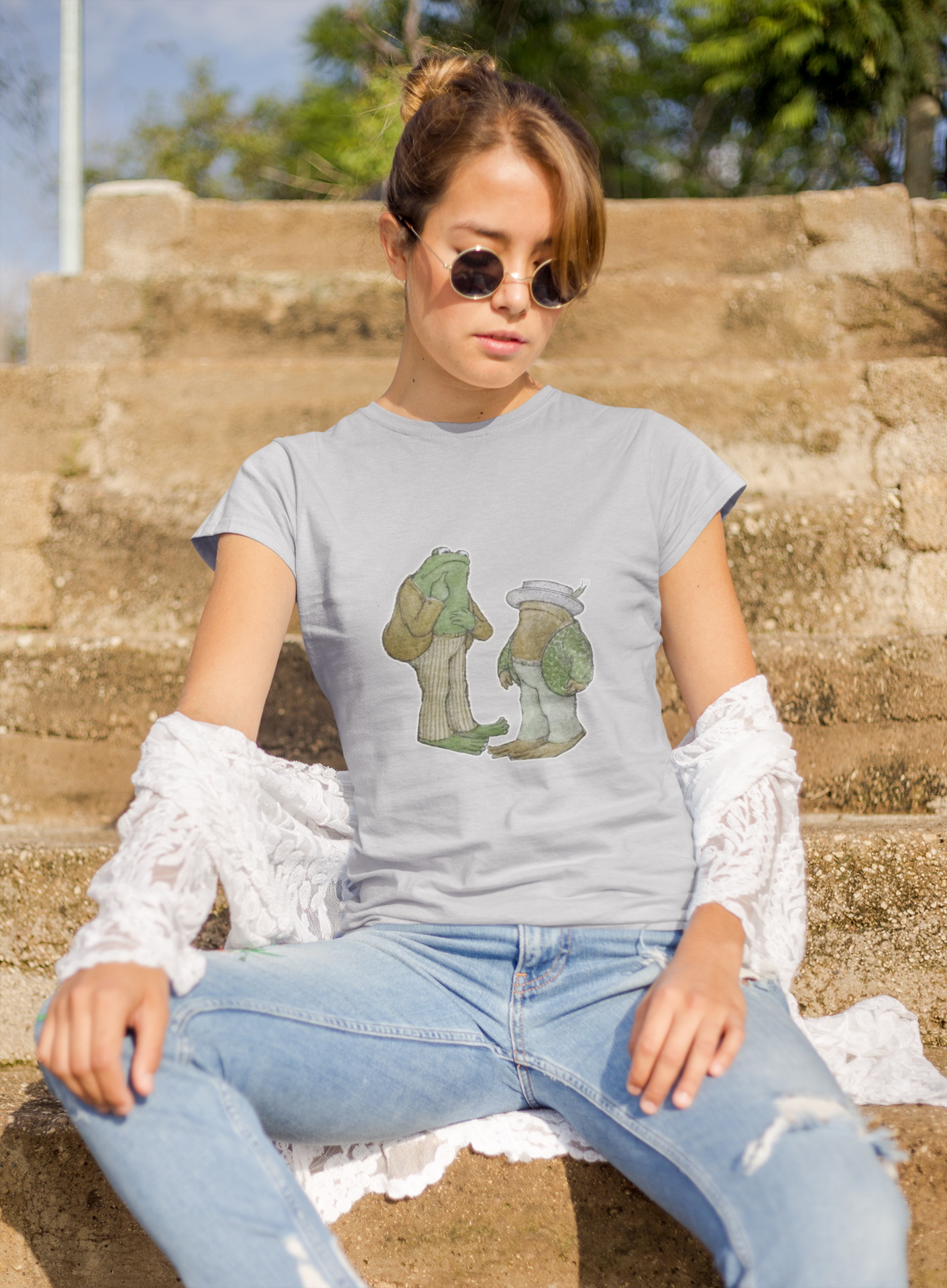 a woman wearing a beige frog and toad  t - shirt