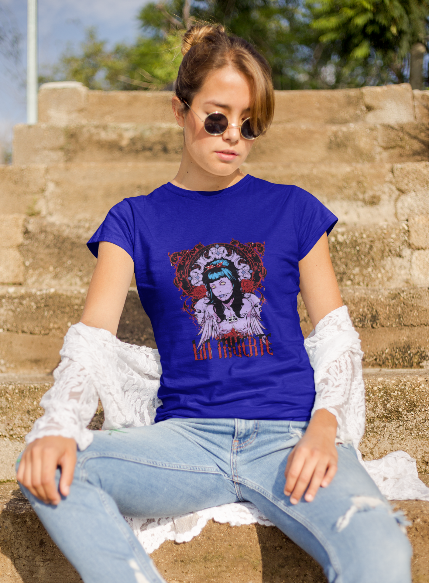 a woman wearing a blue La Muerte T-shirt