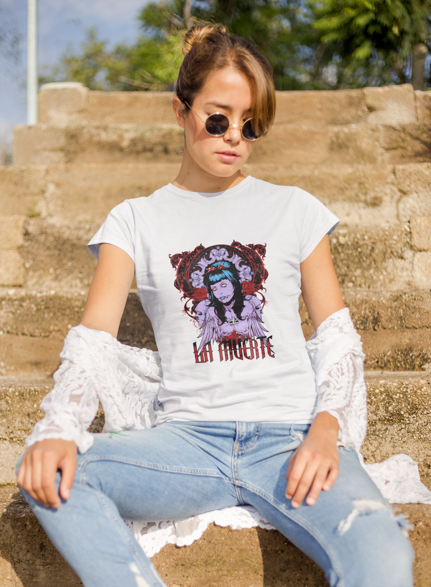 a woman wearing a white La Muerte T-shirt