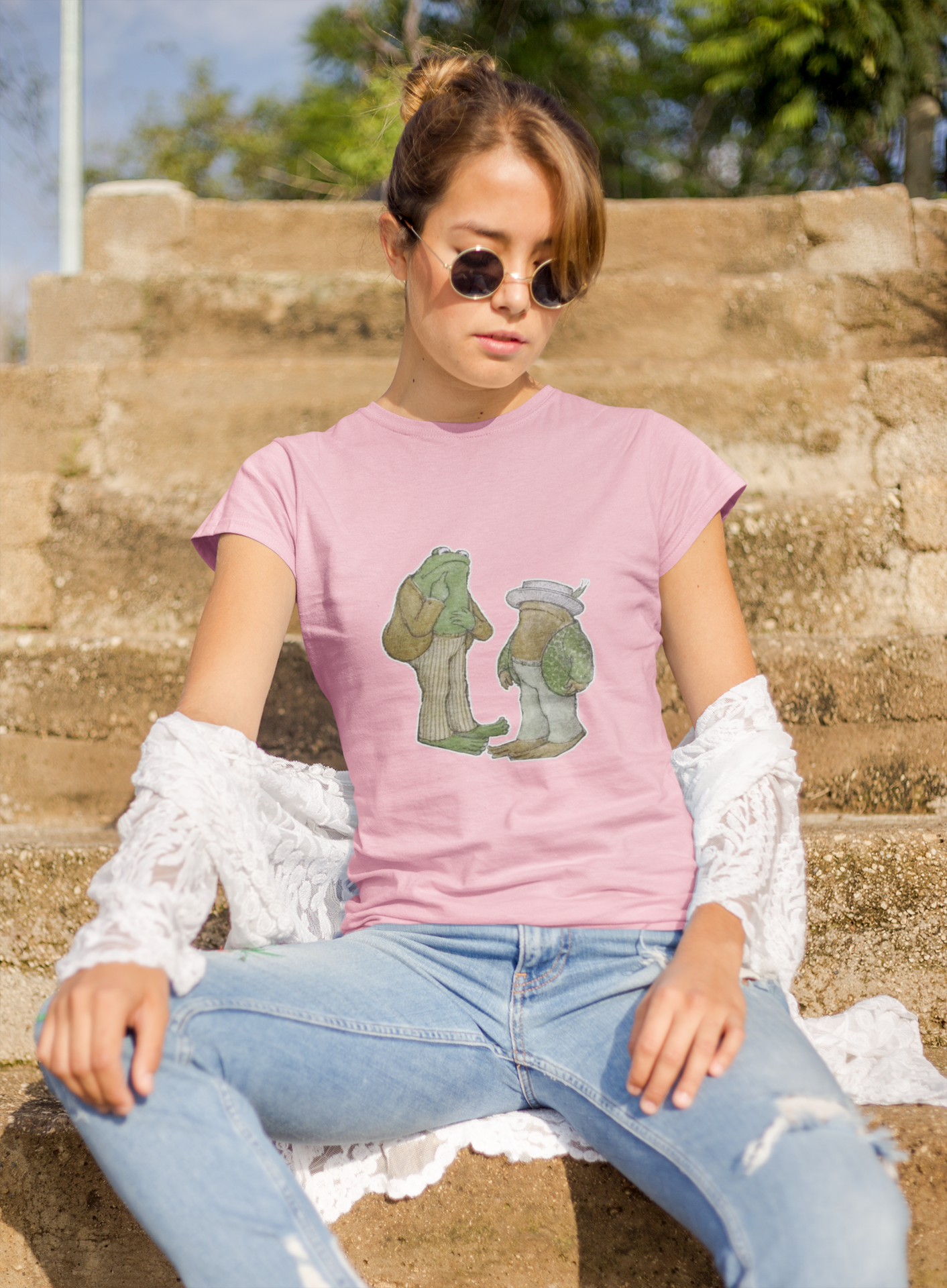 a woman wearing a pink frog and toad  t - shirt