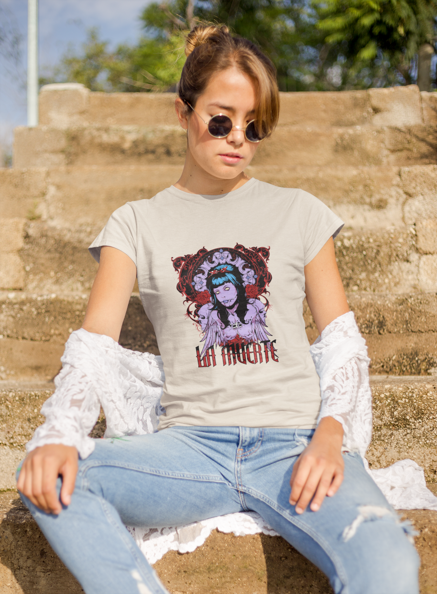 a woman wearing a beige La Muerte T-shirt