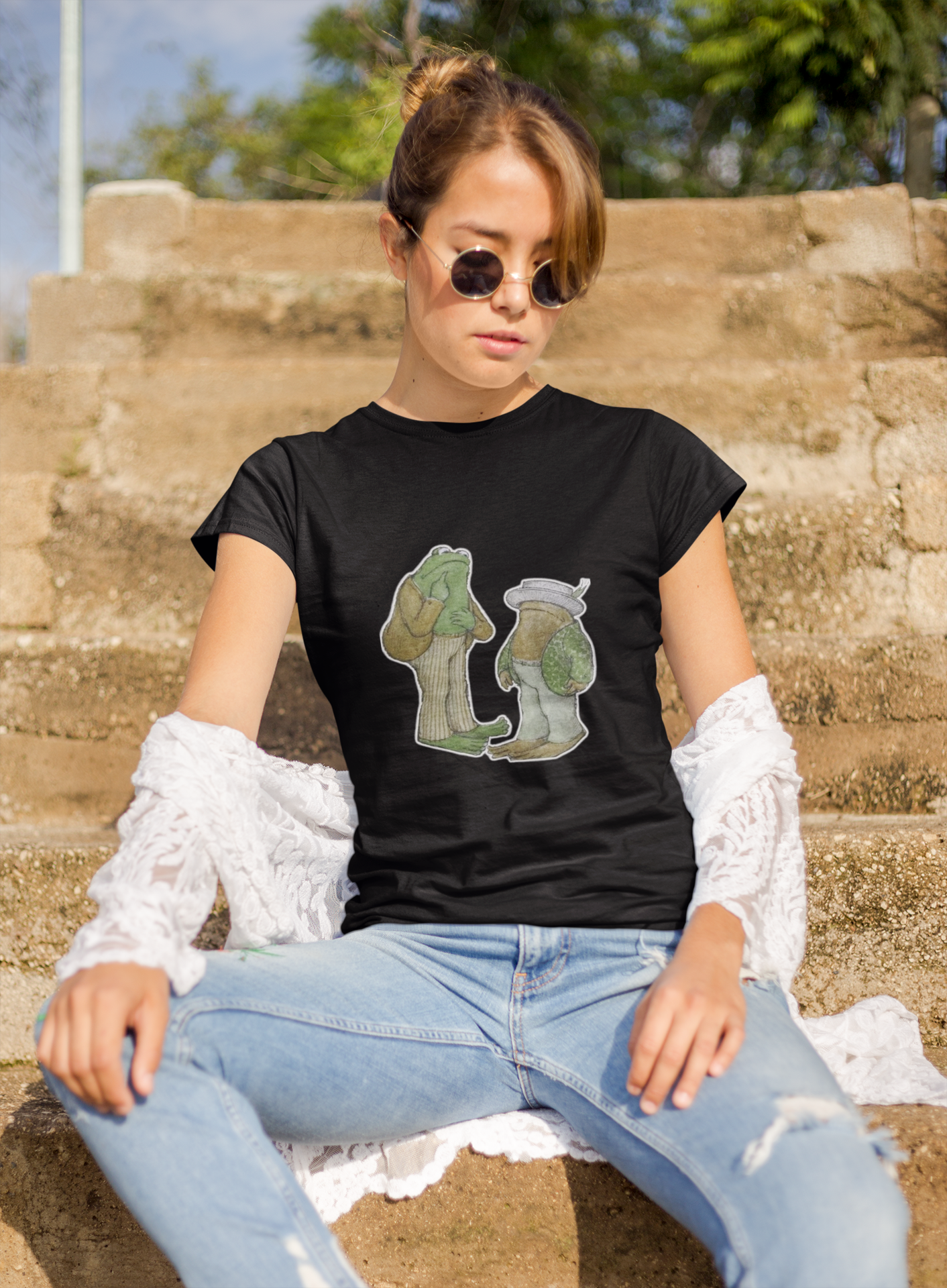 a woman wearing a black frog and toad  t - shirt