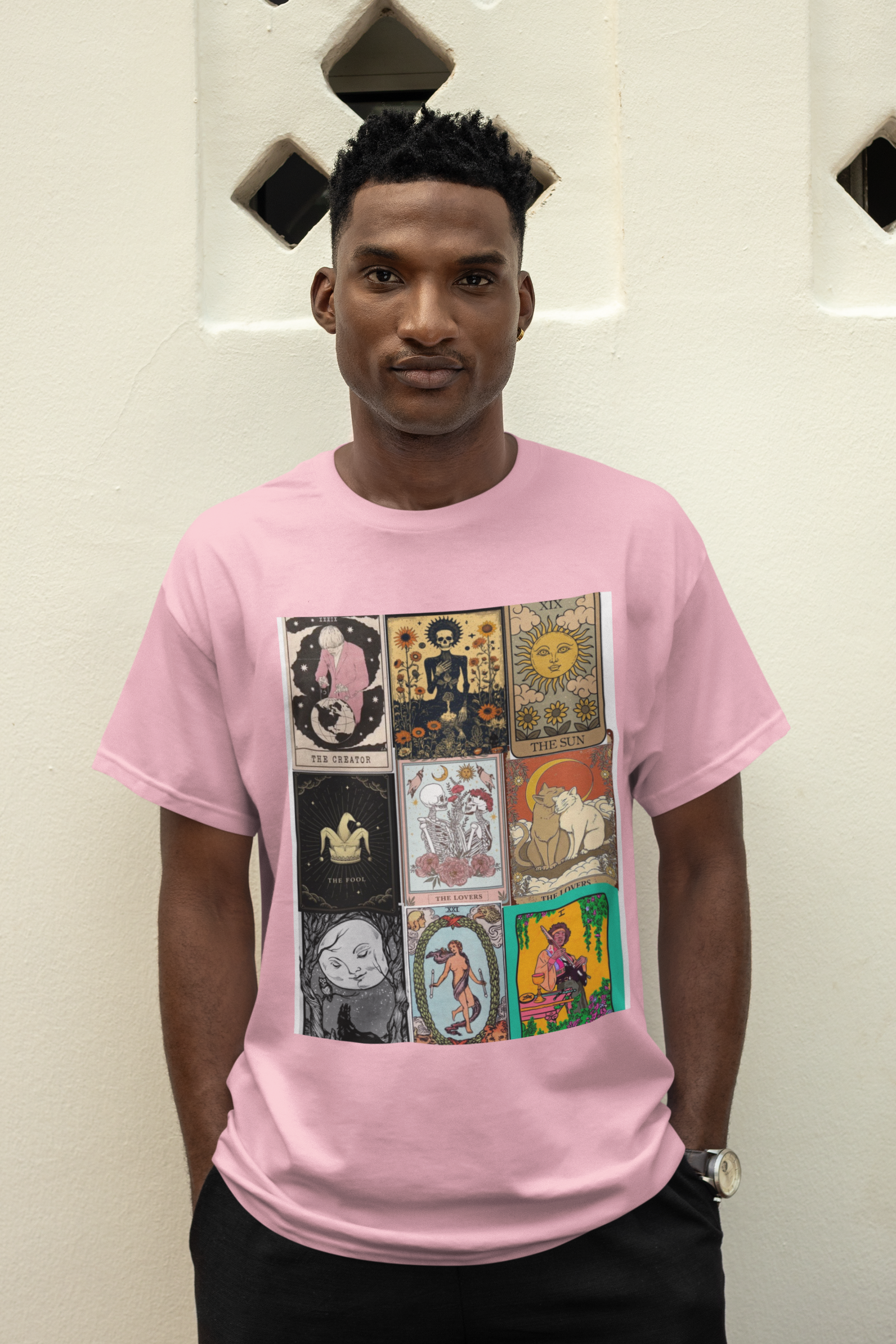 a man wearing a pink Tarrot card design T-shirt