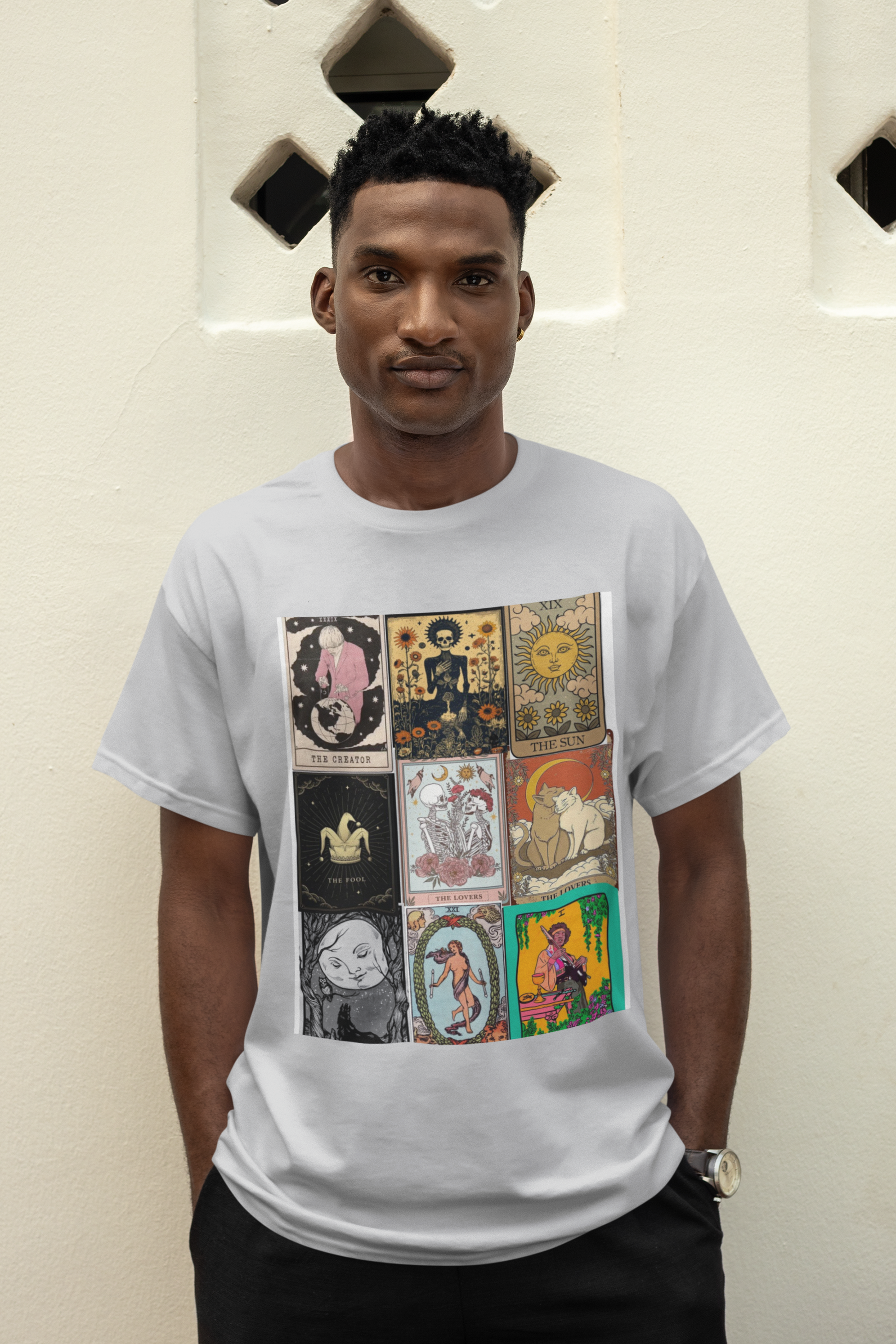 a man wearing a grey Tarrot card design T-shirt