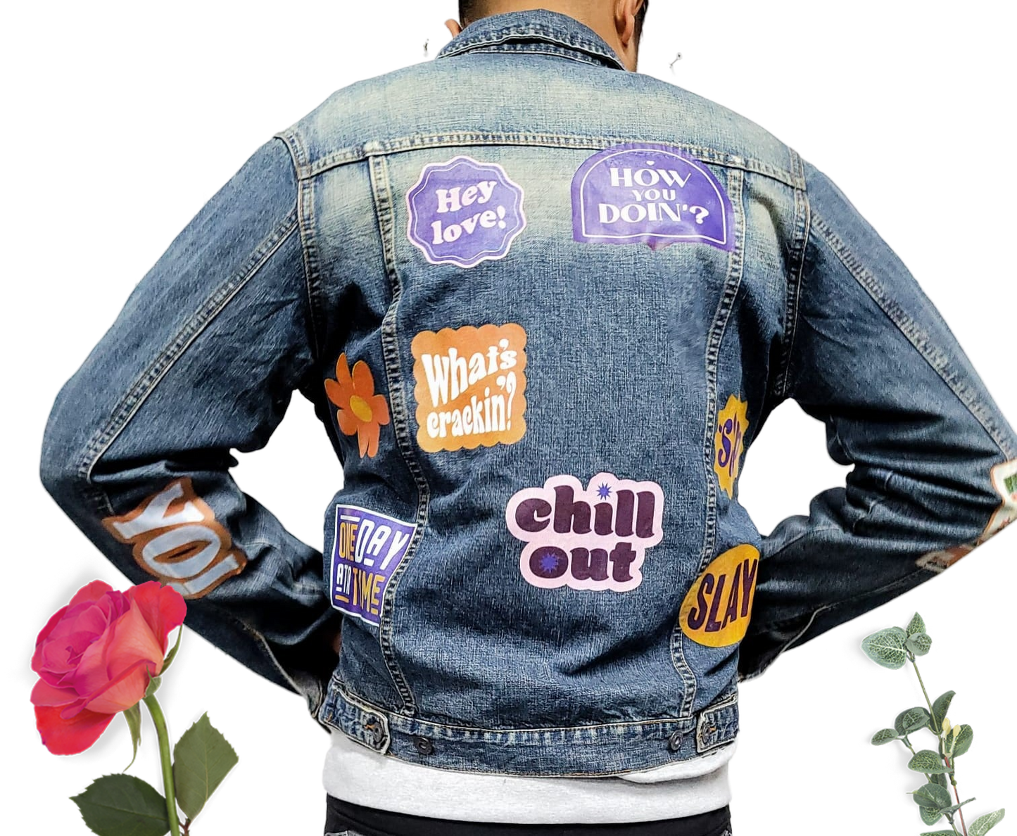 a man wearing a jean jacket with stickers on it