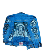 a denim jacket with an astronaut monkey on it