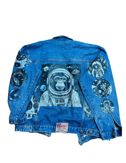 a denim jacket with an astronaut monkey on it
