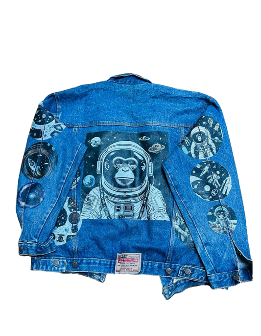a denim jacket with an astronaut monkey on it