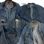 a pile of blue jean jackets laying on top of each other