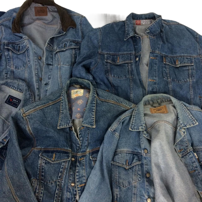 a pile of blue jean jackets laying on top of each other