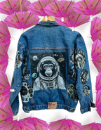 a denim jacket with a picture of an astronaut monkey on it