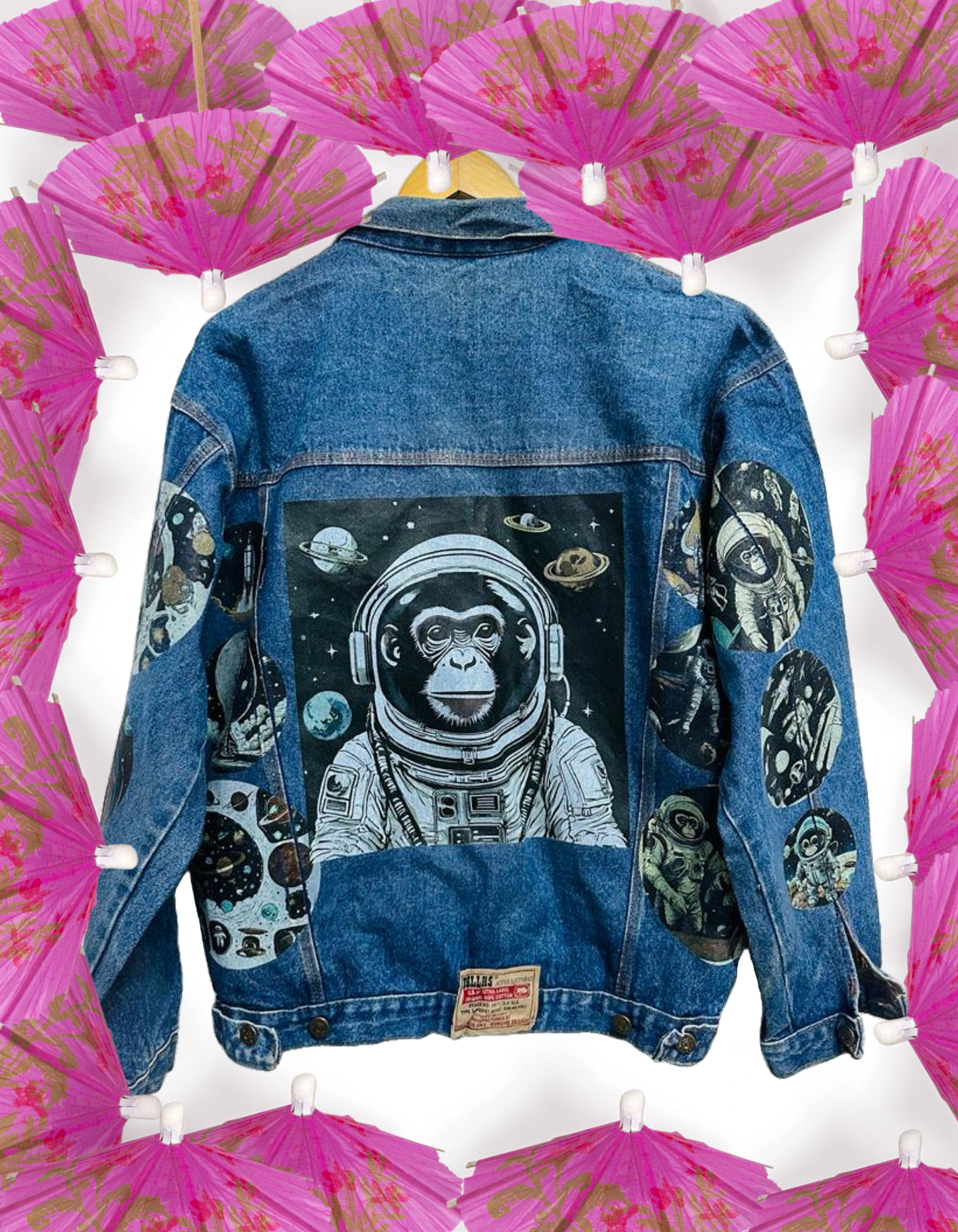 a denim jacket with a picture of an astronaut monkey on it