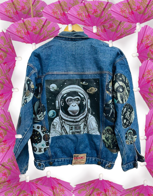 a denim jacket with a picture of an astronaut monkey on it